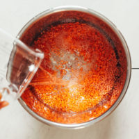 Pouring water over red lentils