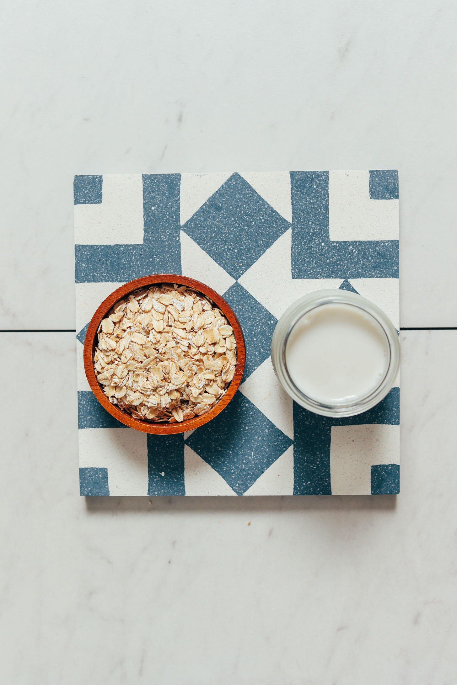 Bowl of rolled oats and glass of dairy-free milk