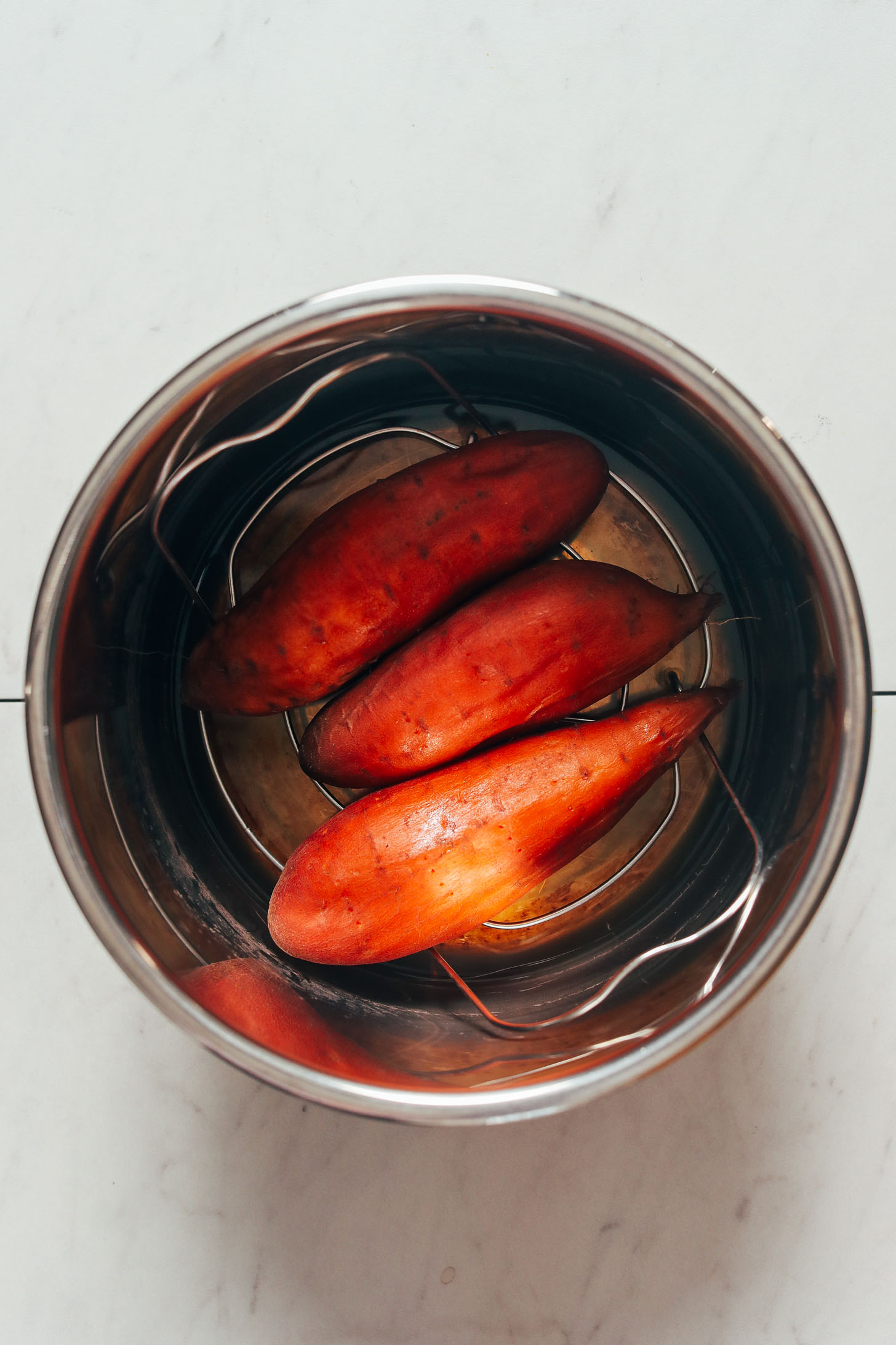 Sweet potatoes on a trivet in an Instant Pot after cooking