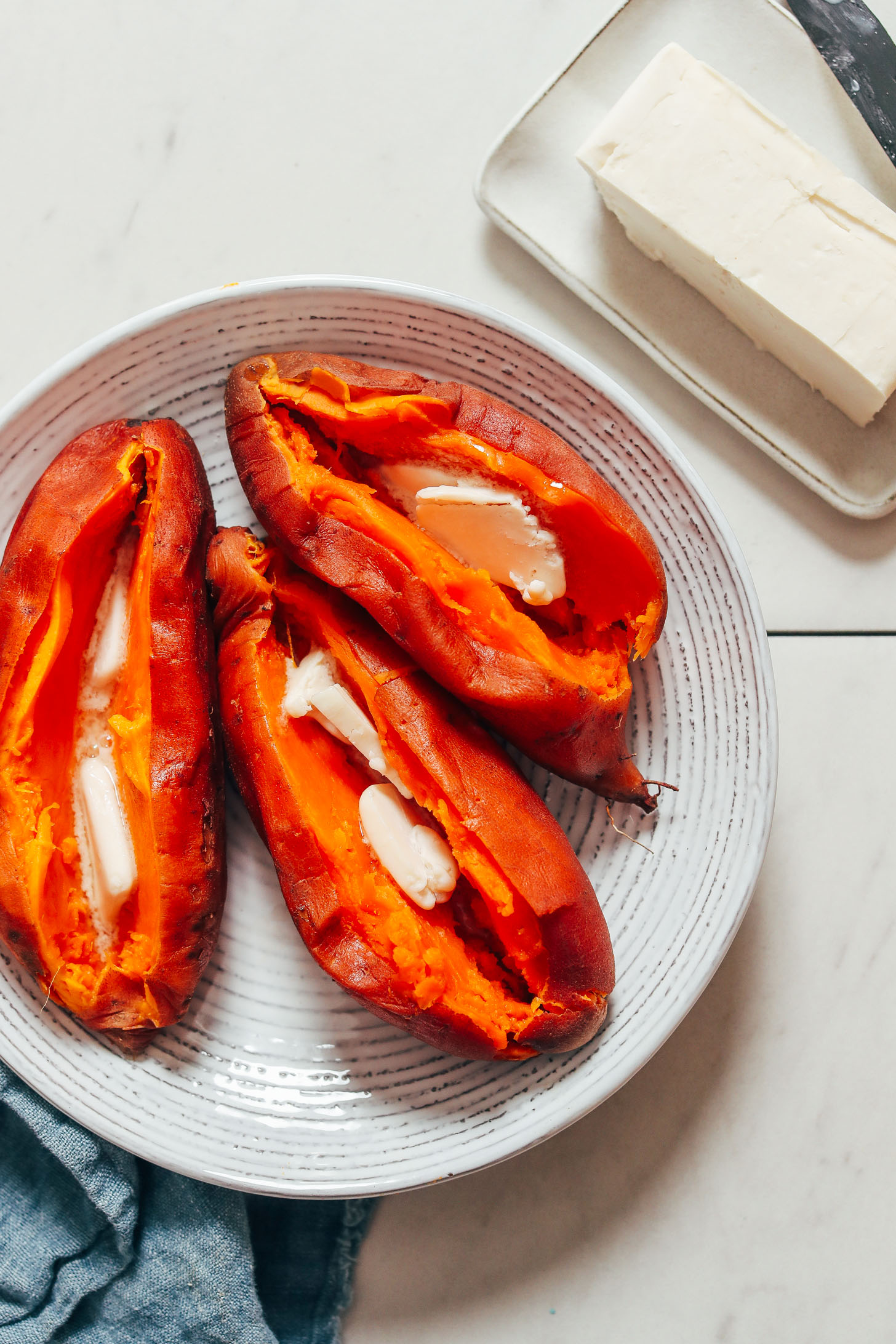 Bowl of Instant Pot sweet potatoes with vegan butter