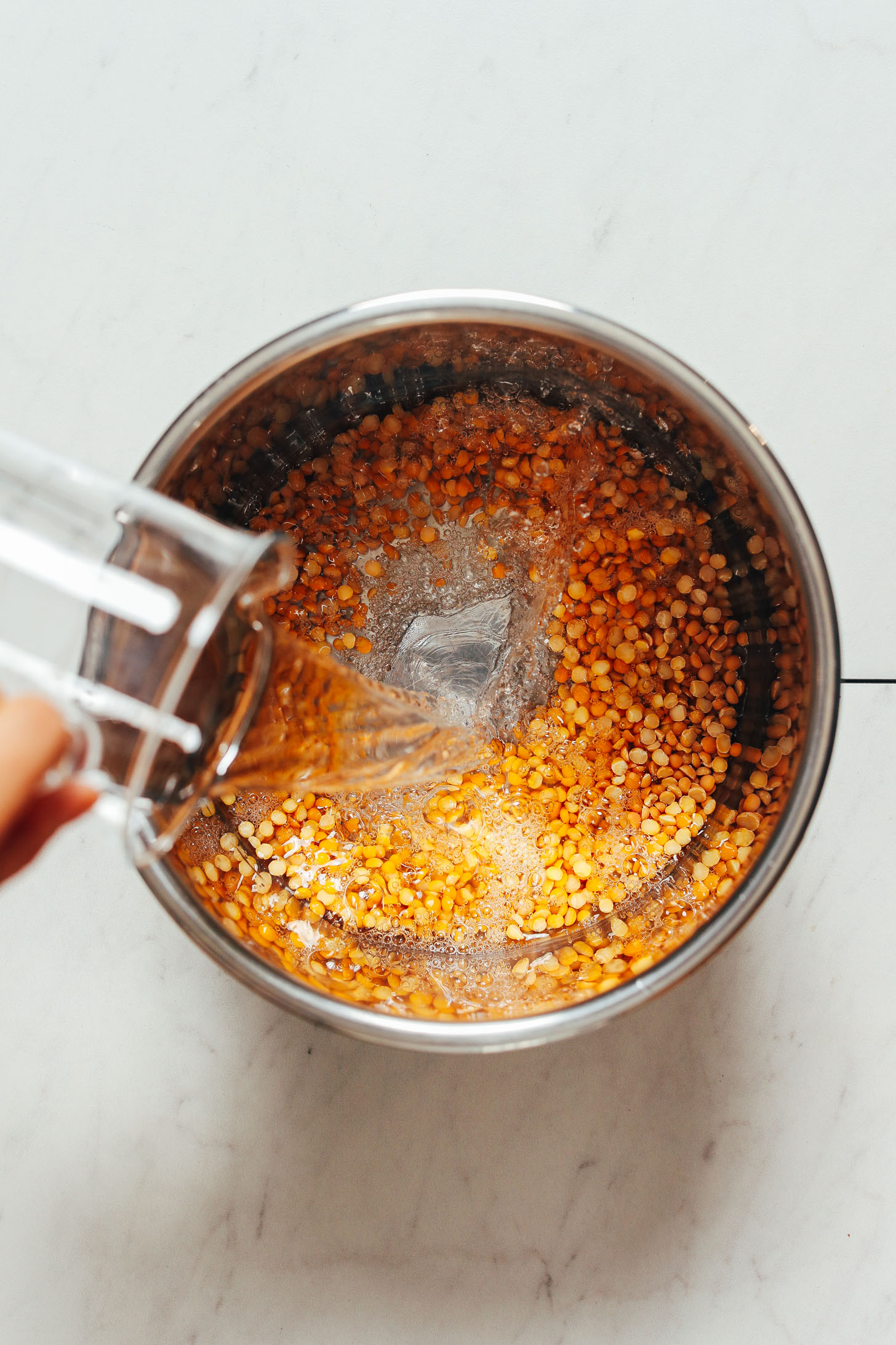 Pouring water over dry yellow split peas