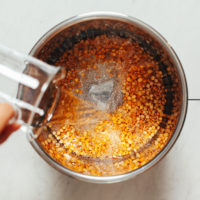 Pouring water into an Instant Pot of yellow split peas