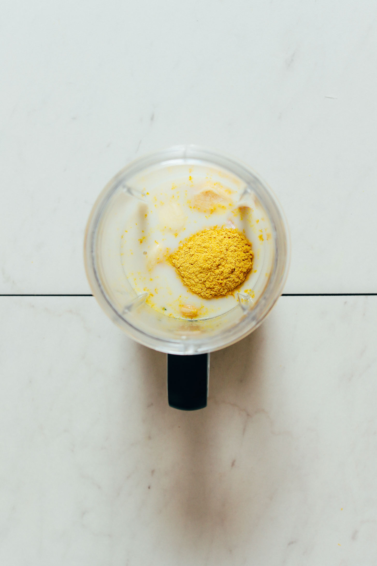 Small blender with vegan alfredo sauce ingredients