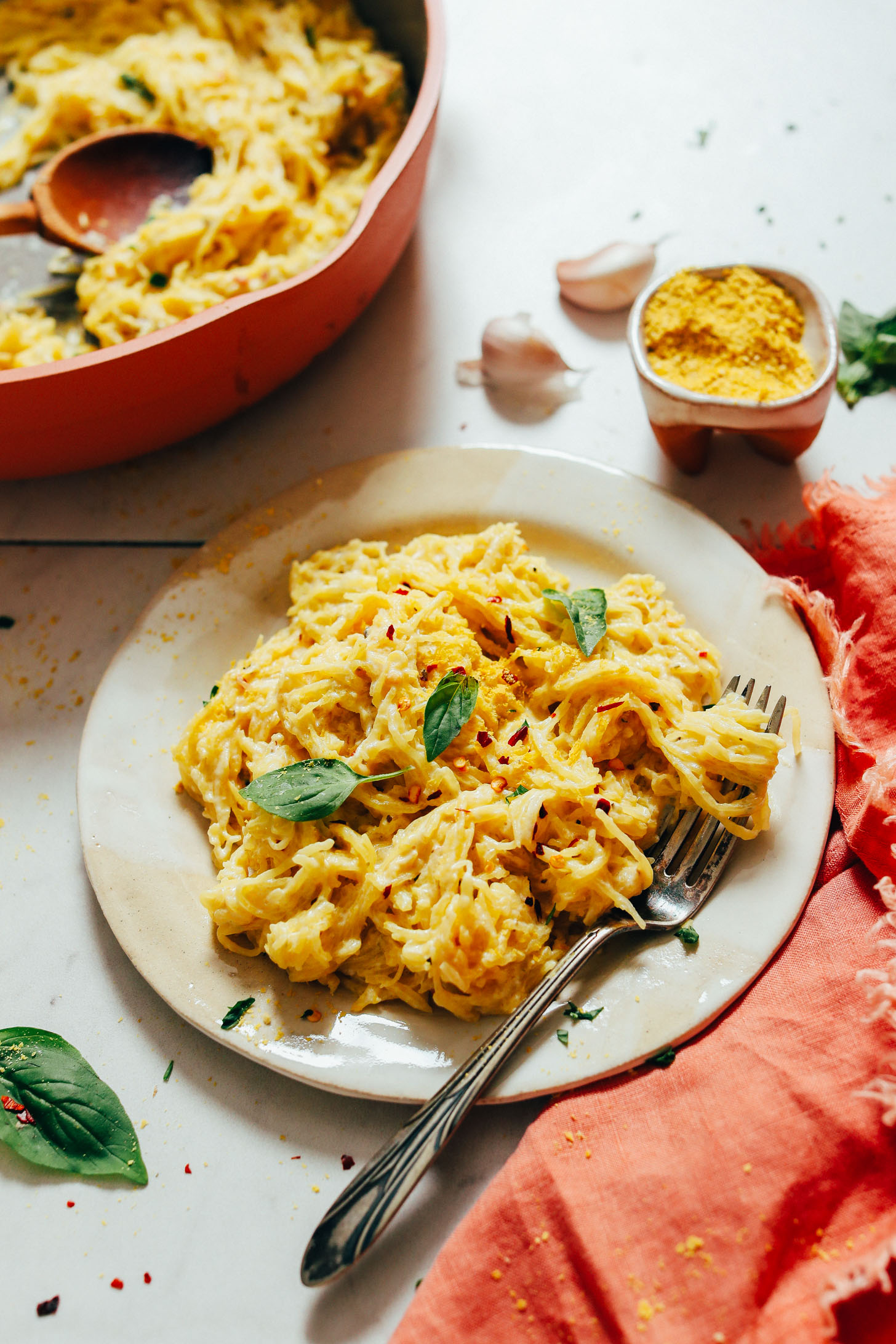 Vintage fork on a plate of spaghetti squash pasta with vegan alfredo sauce