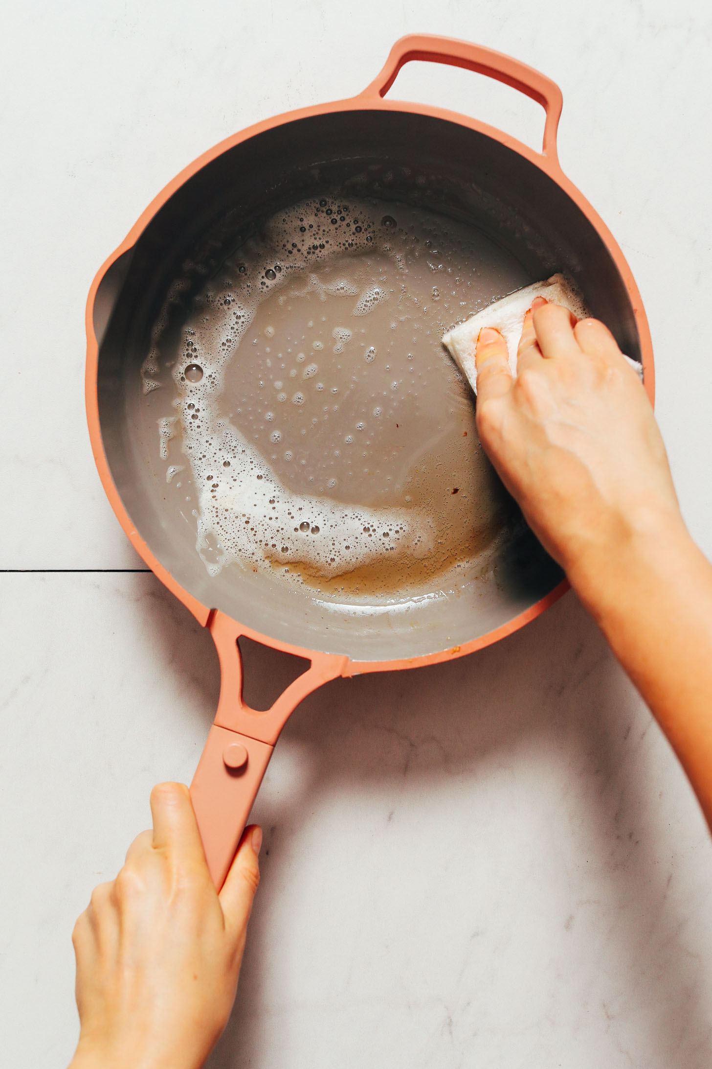 Using a soapy sponge to clean the Always Pan