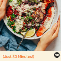 Holding the sides of a vegan sweet potato nourish bowl