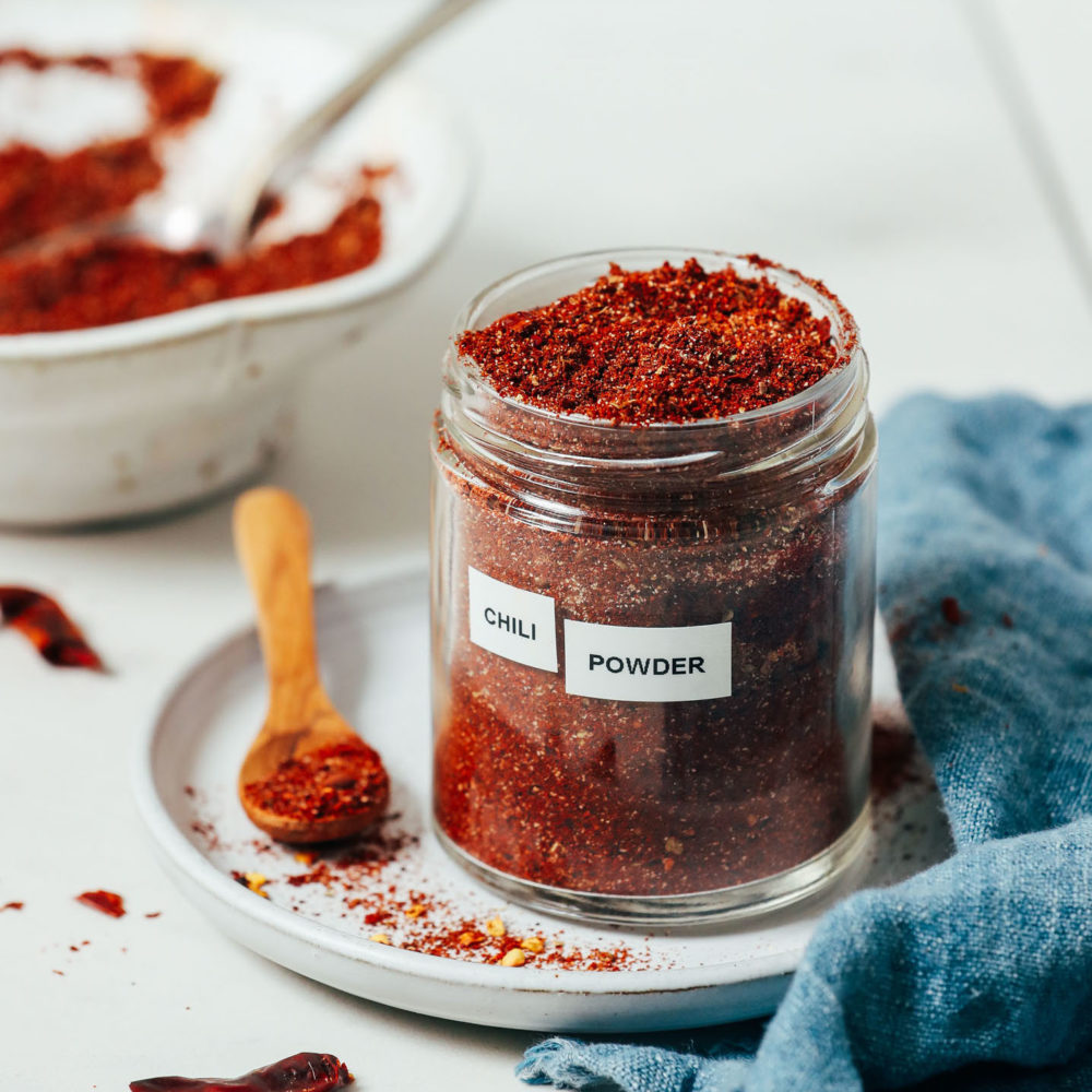Spoonful and jar of chili powder for our guide on how to make chili powder