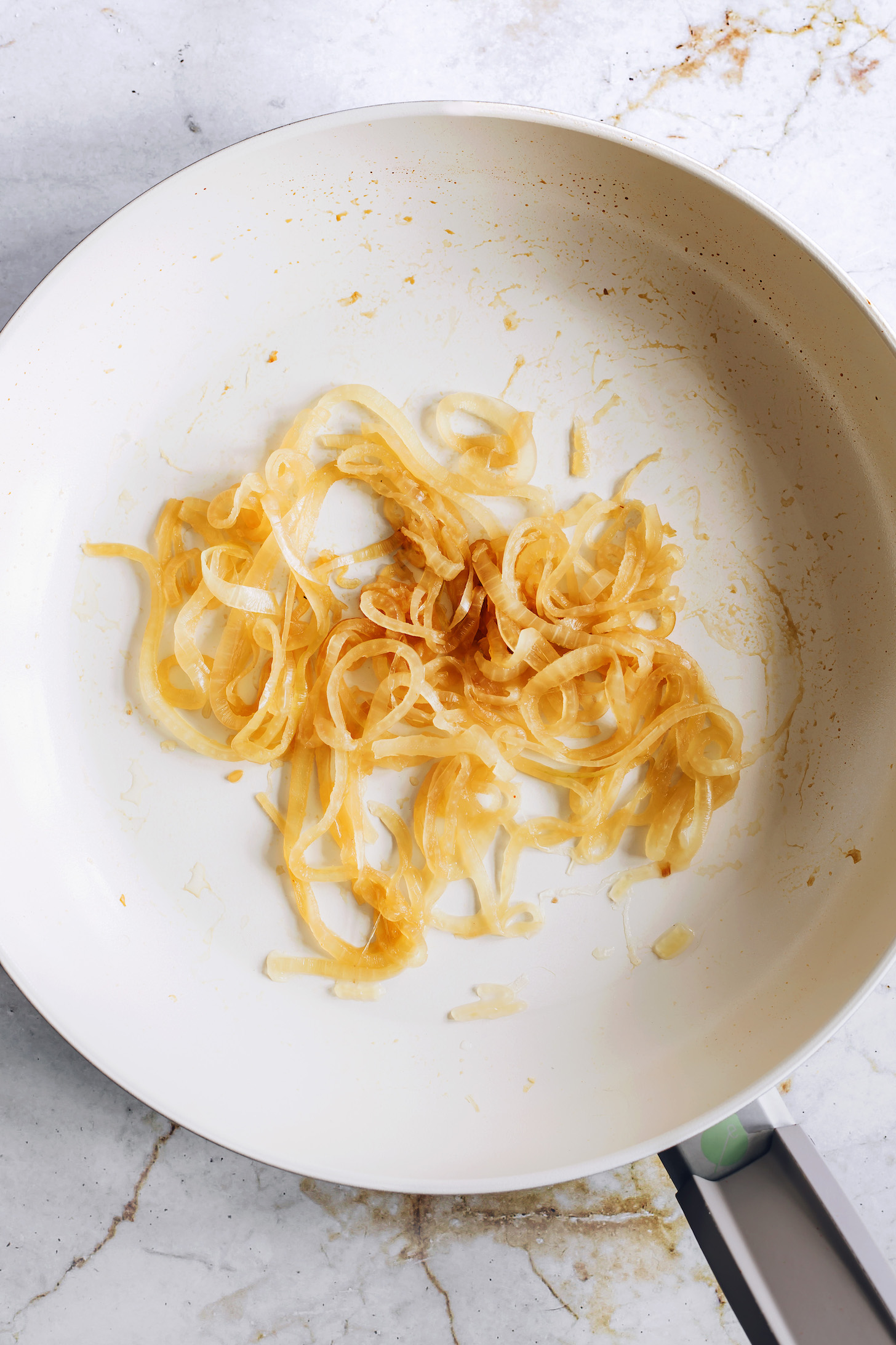 A pan of caramelized onions made without oil