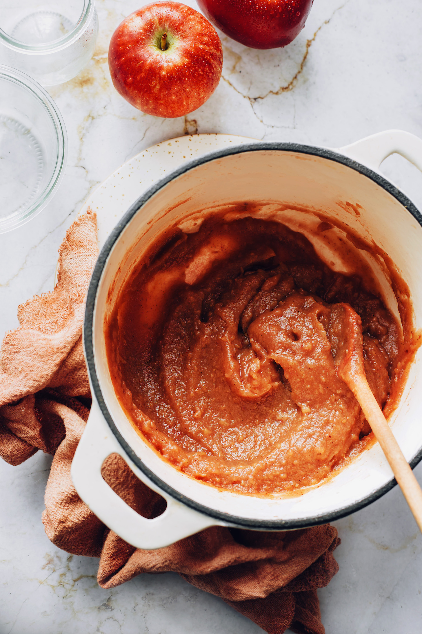Wooden spoon in a pot of caramelized apple butter