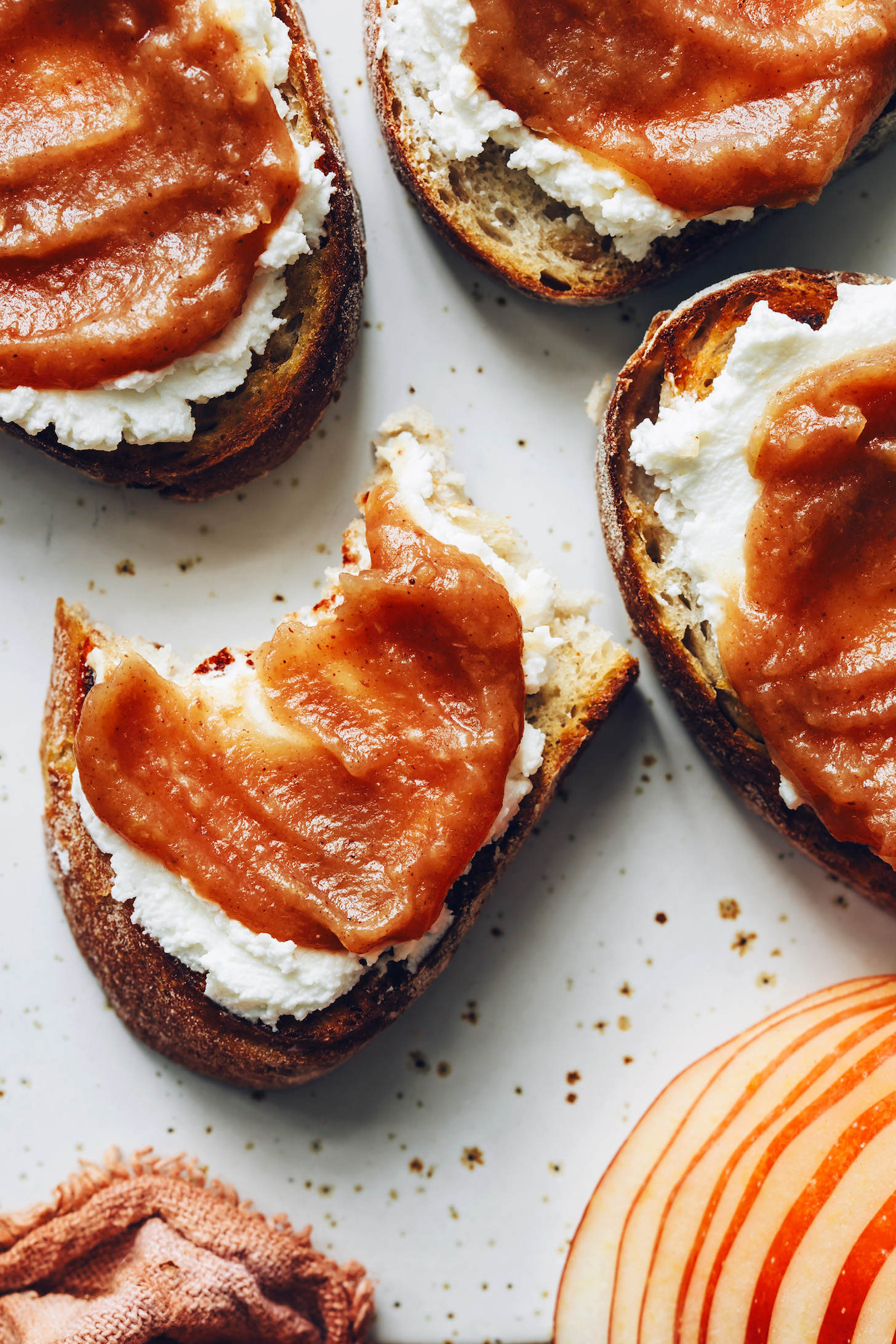 Slices of toast topped with vegan cream cheese and apple butter