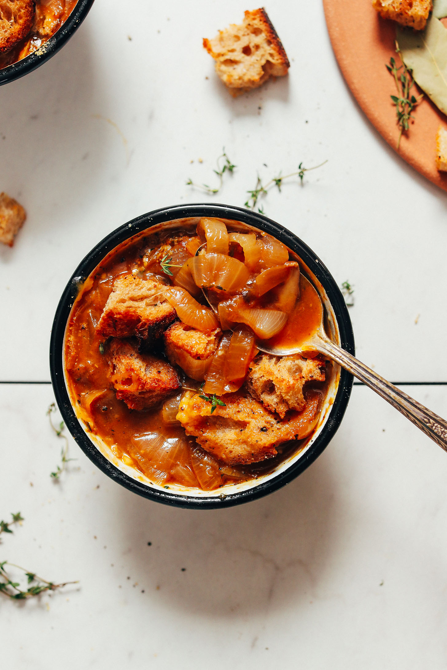 Vintage spoon in a bowl of caramelized onion French onion soup