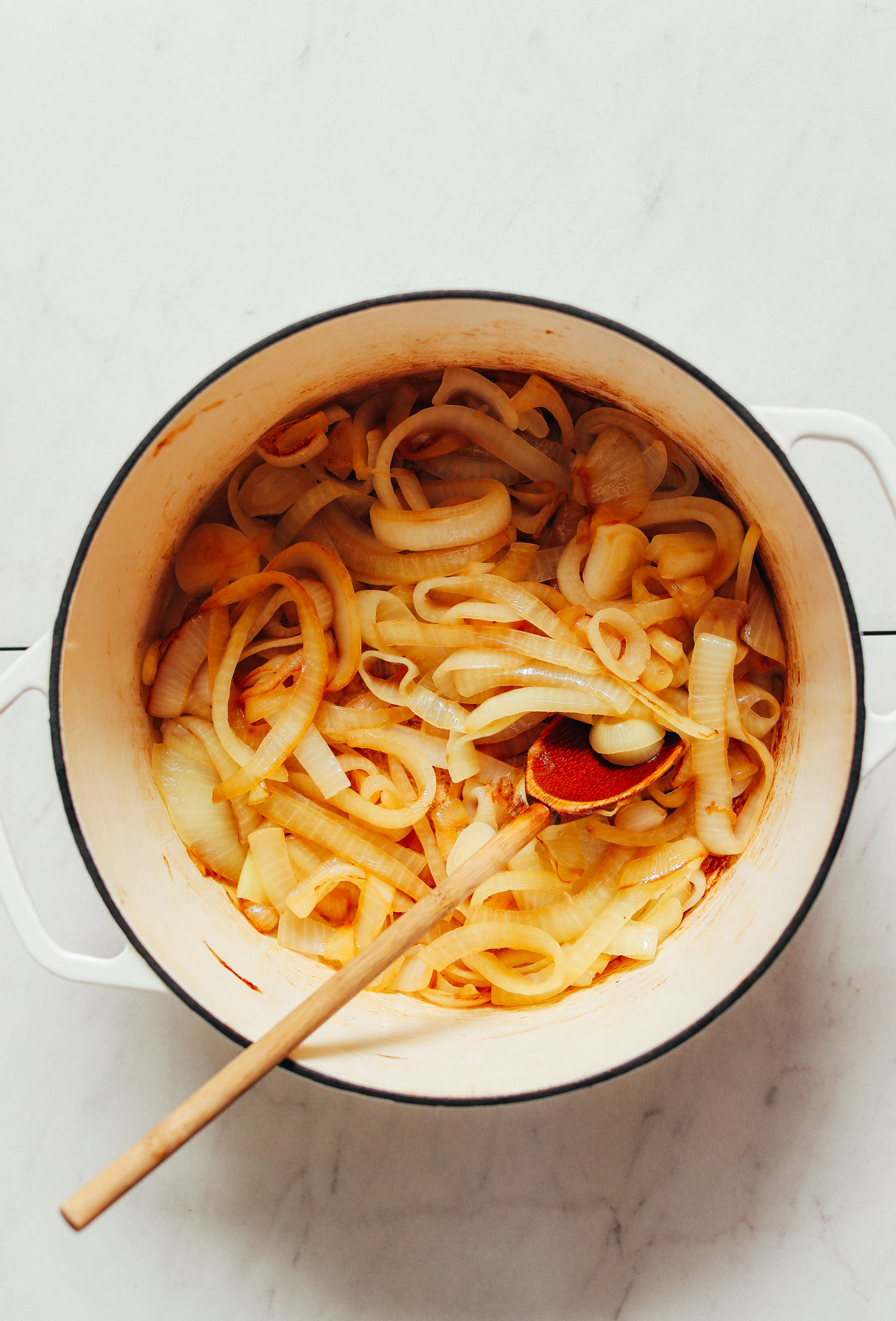 Partially caramelized onions in a Dutch oven