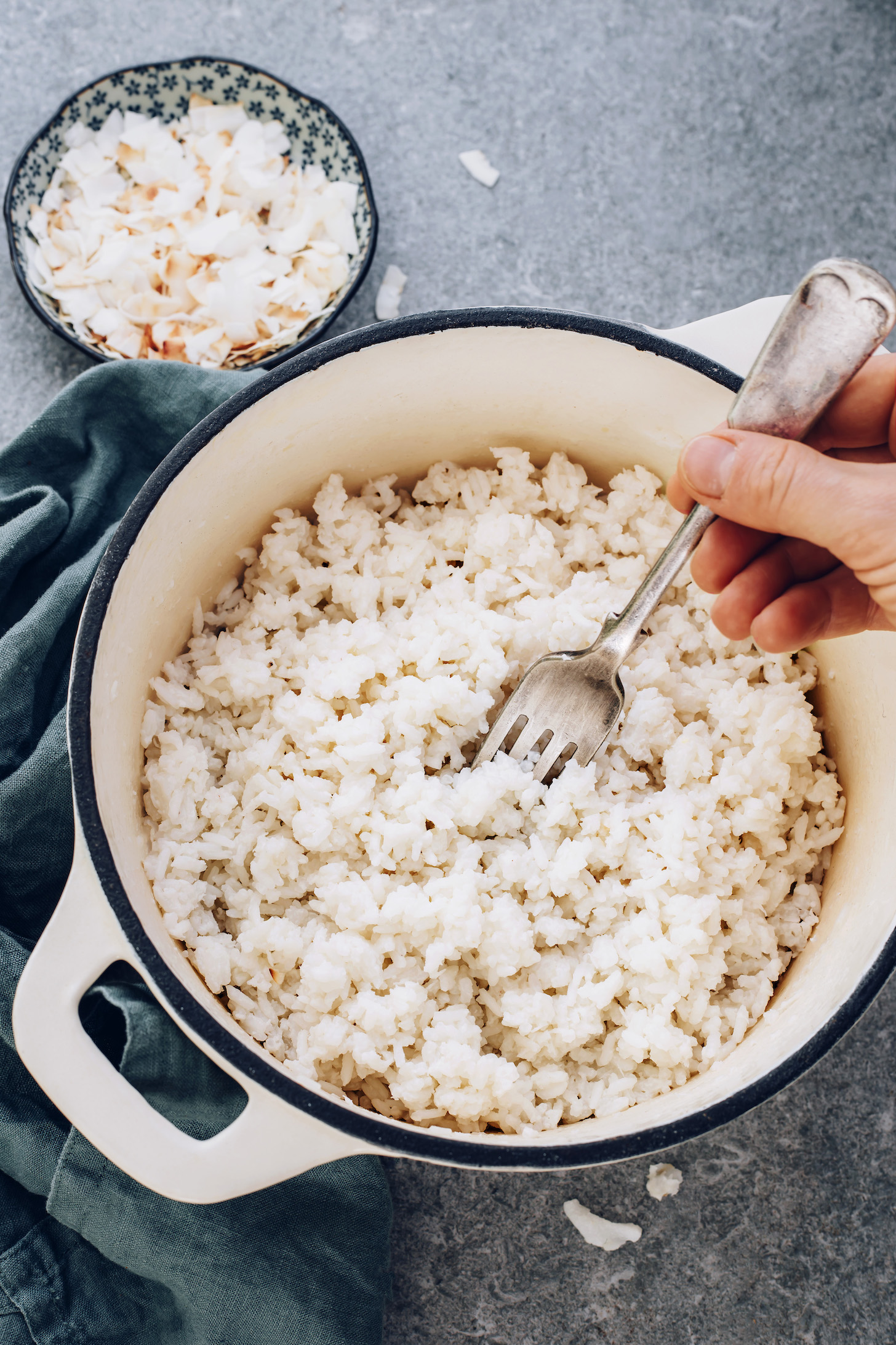 Fork in a pan of fluffy coconut rice