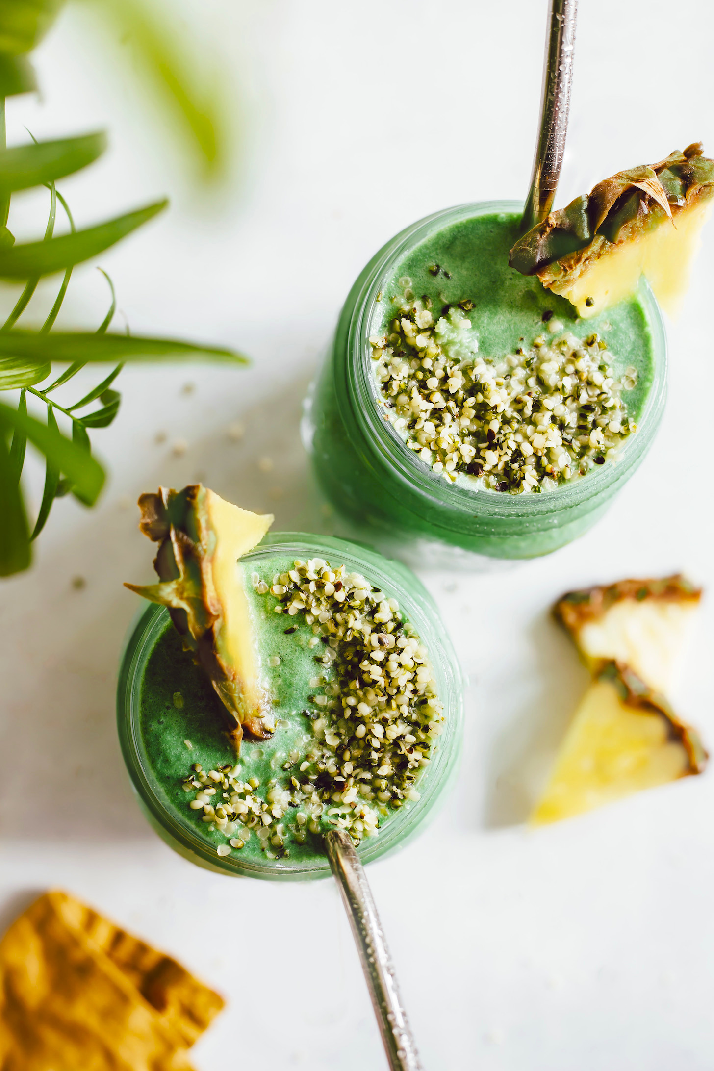 Top down shot of two glasses of our green lemonade smoothie topped with hemp seeds