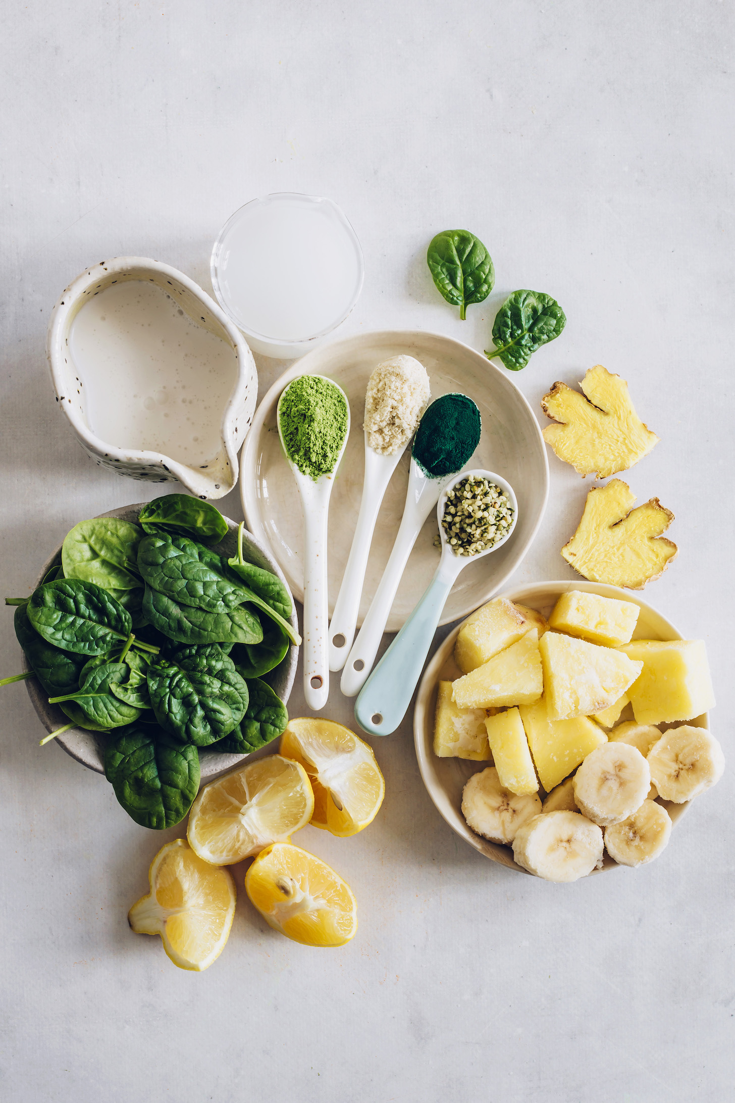 Baby spinach, lemons, pineapple, banana, ginger, hemp seeds, dairy-free milk, coconut water, baobab powder, moringa, and spirulina