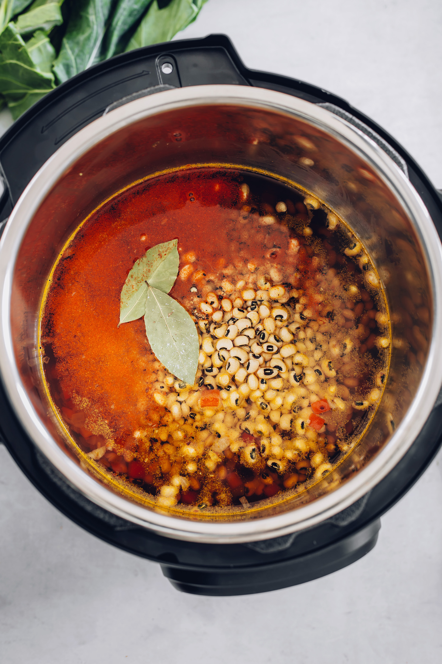 Instant Pot with black eyed peas, broth, and seasonings