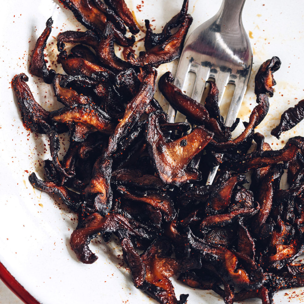 Fork on a plate of Crispy Shiitake Bacon