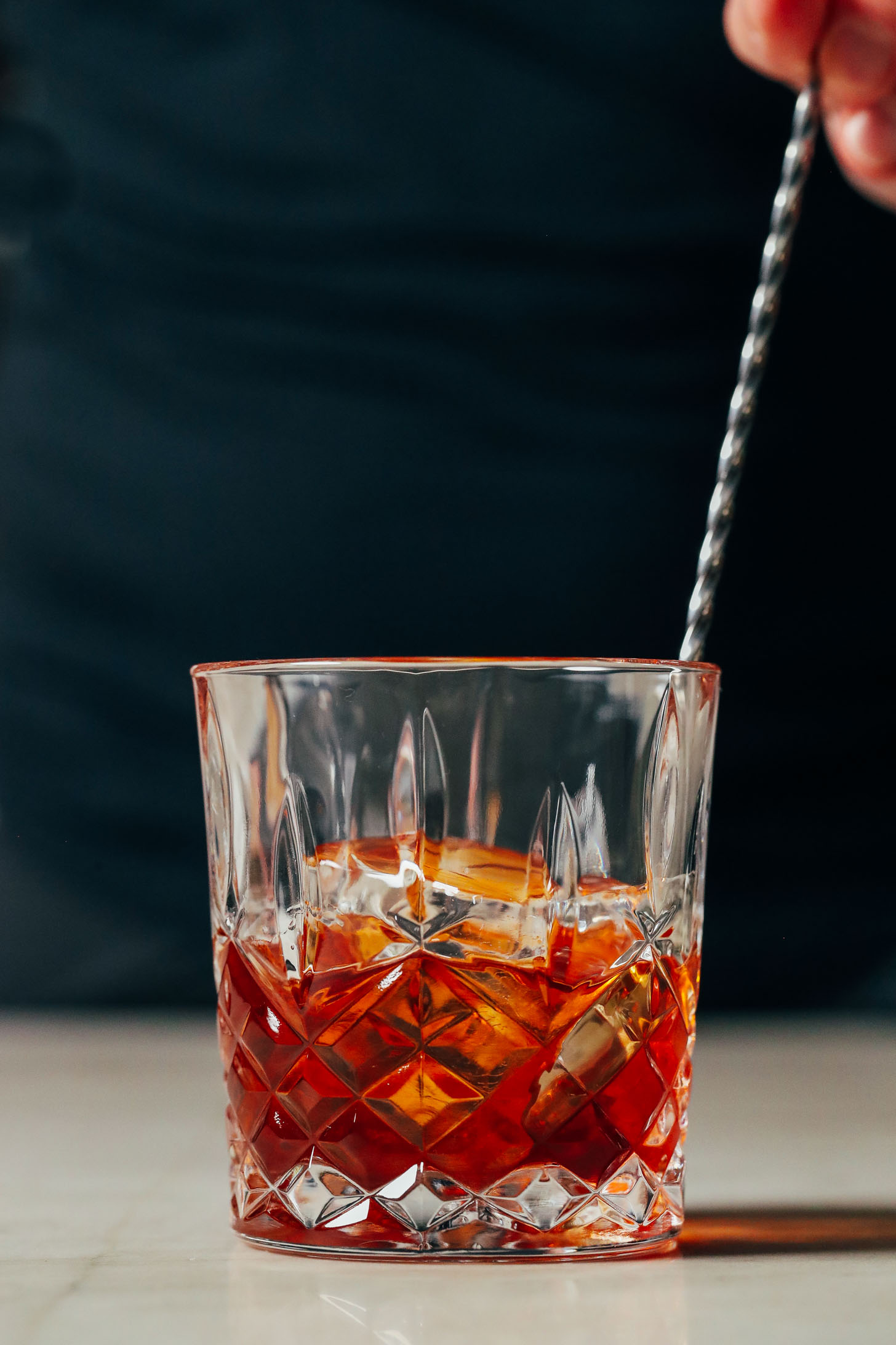 Using a bar spoon to stir an Old Fashioned