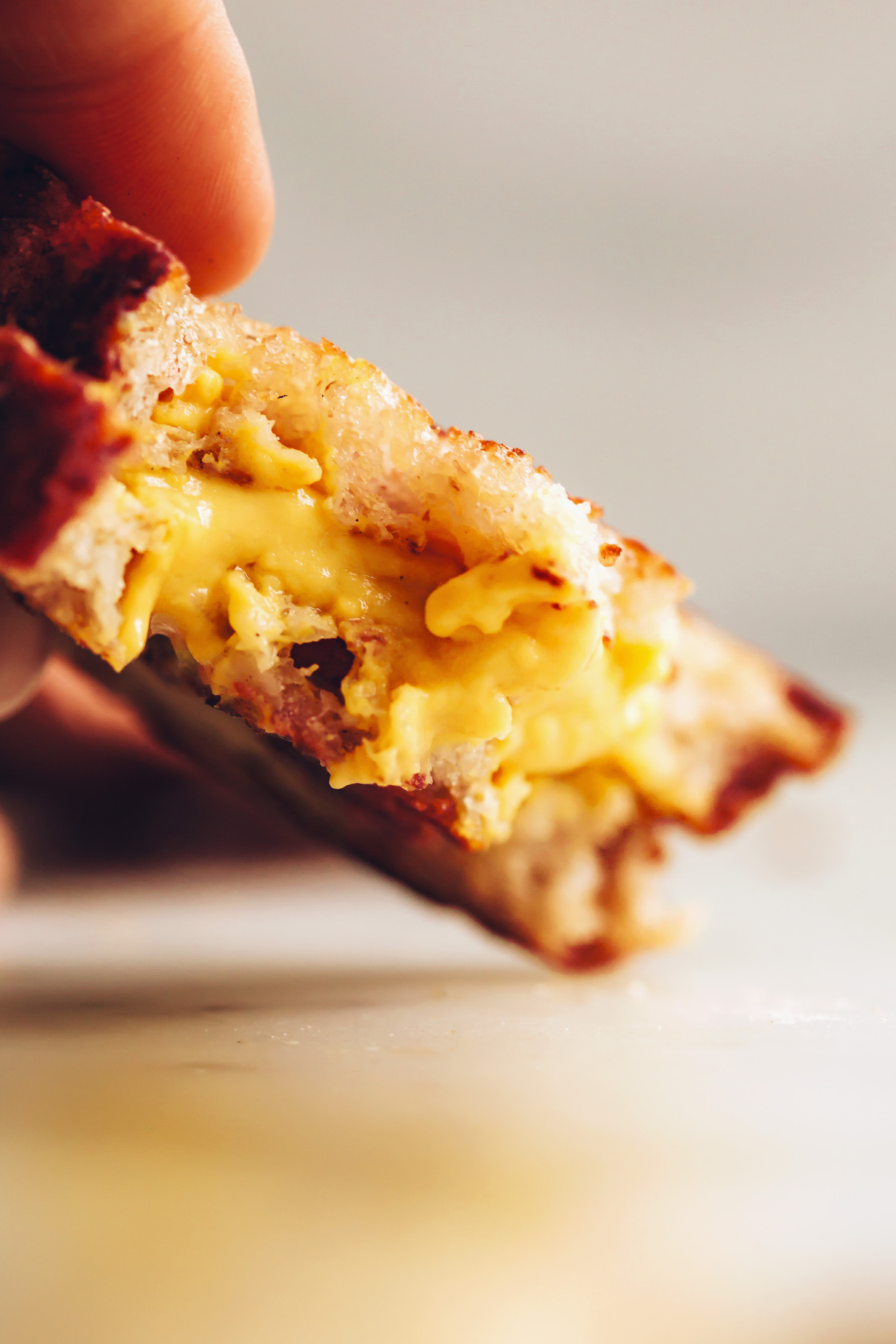 Close up shot of the melty cheddar cheese in our vegan grilled cheese sandwich