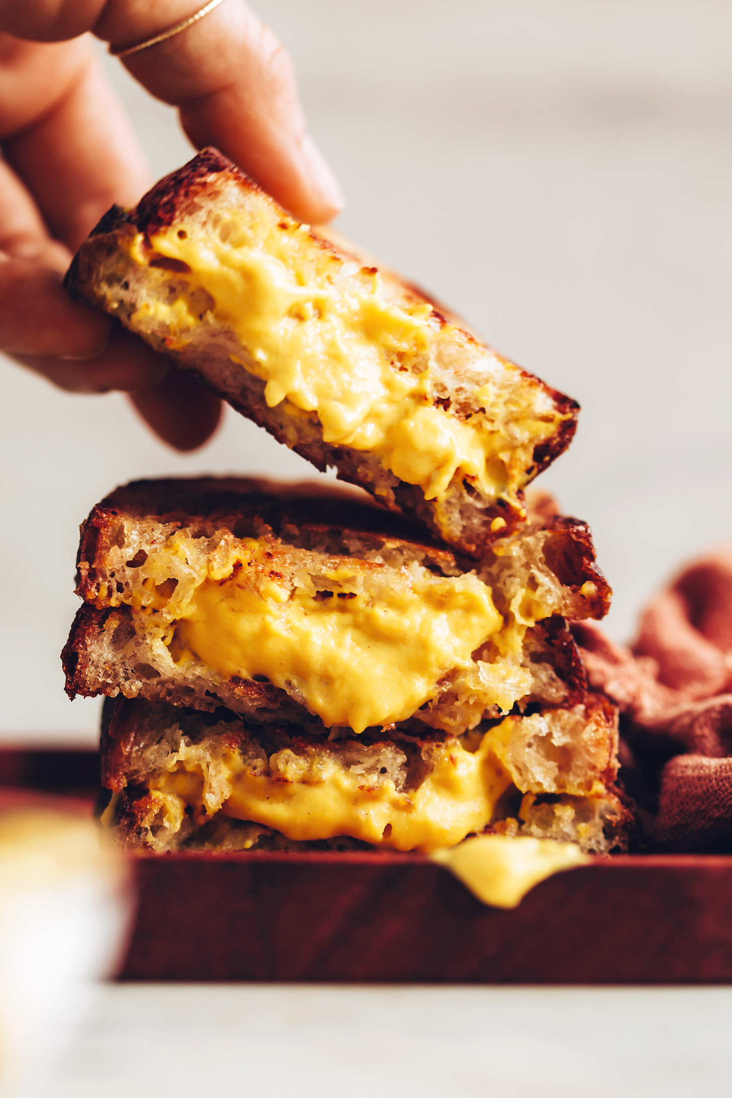Picking up a slice of our vegan grilled cheese sandwich