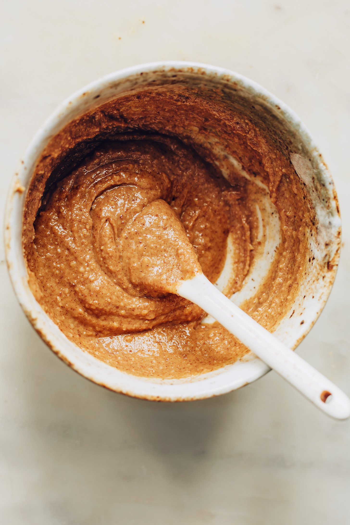 Bowl of peanut butter mixed with almond flour, coconut sugar, and sea salt