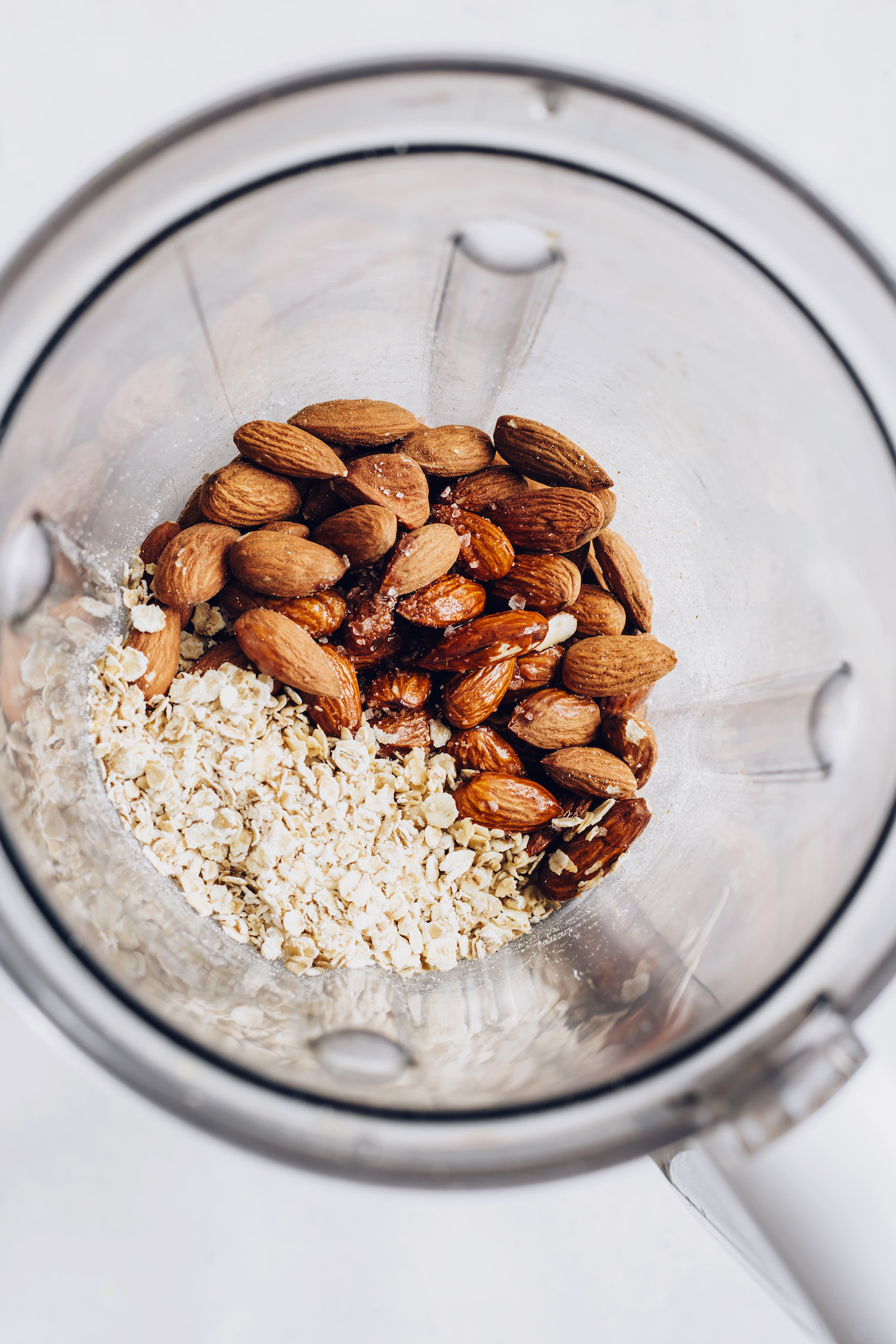 Blender with almonds, oats, sea salt, maple syrup, and coconut oil