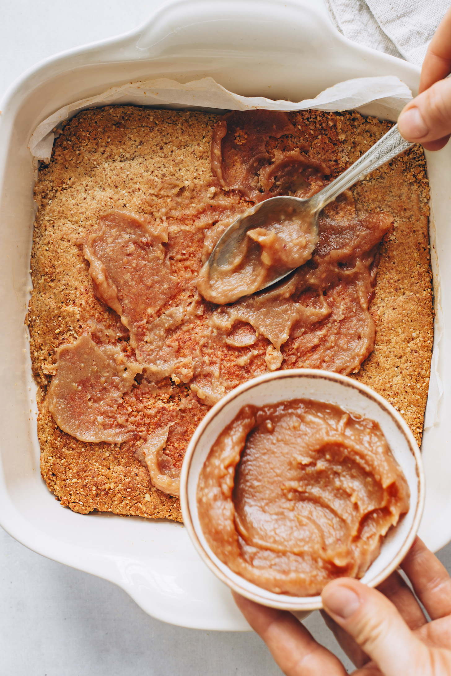 Spreading homemade apple butter over the crust