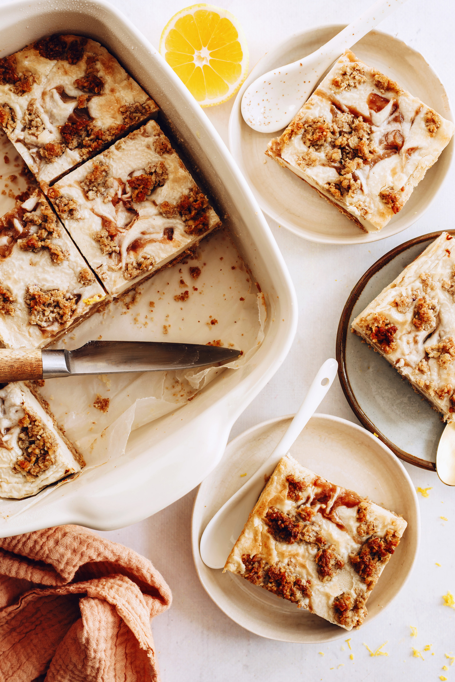 Pan and plates filled with apple butter vegan cheesecake bars