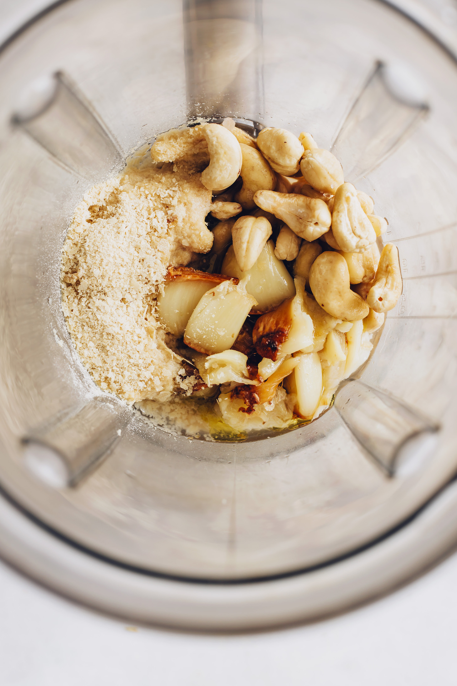 Blender of cashews, roasted garlic, nutritional yeast, olive oil, and sea salt