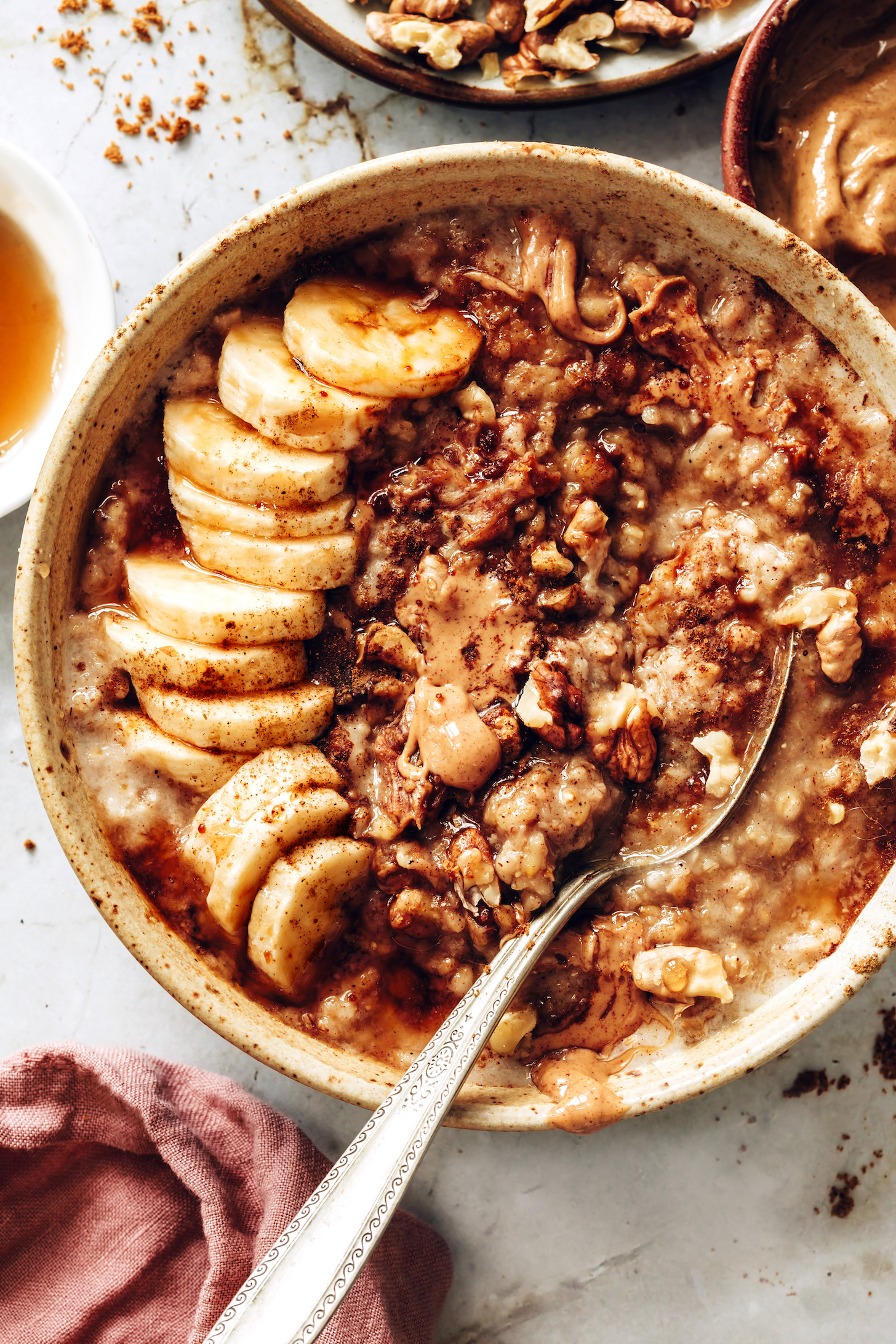 Bowl of cozy banana bread steel cut oats with walnuts