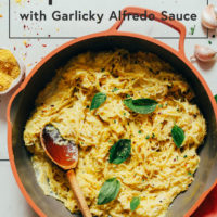 Pan of spaghetti squash alfredo topped with fresh basil
