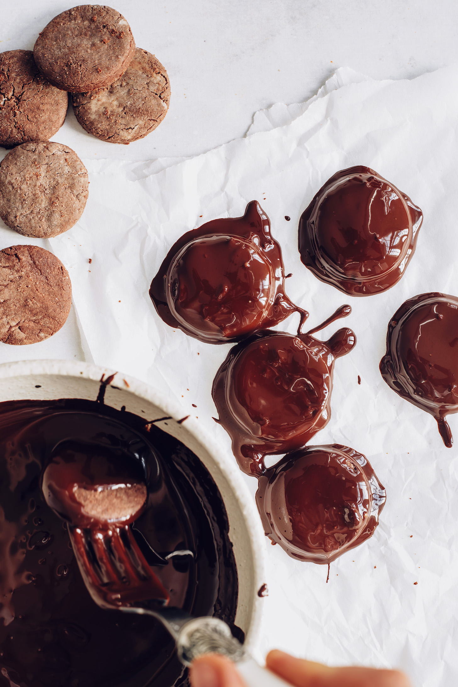 Dipping chocolate mint cookies into melted chocolate