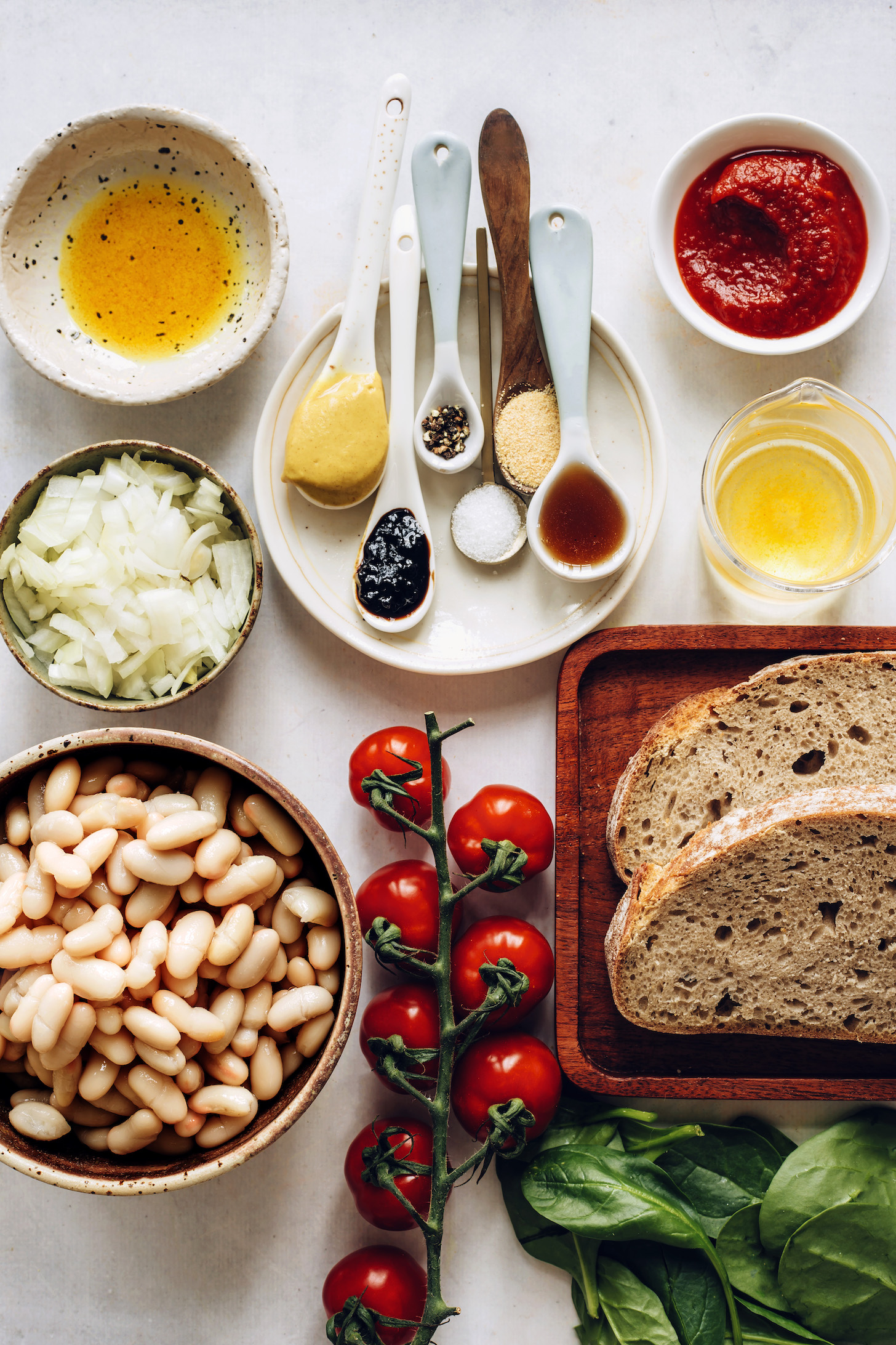 Sourdough bread, tomatoes, spinach, white beans, onions, olive oil, mustard, molasses, salt, pepper, garlic powder, maple syrup, apple cider vinegar, and tomato paste