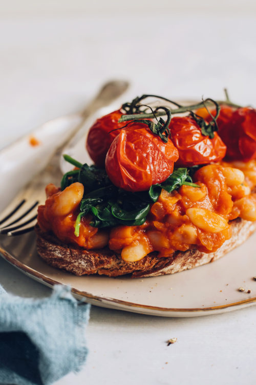 Roasted tomatoes, spinach, and baked beans on toast