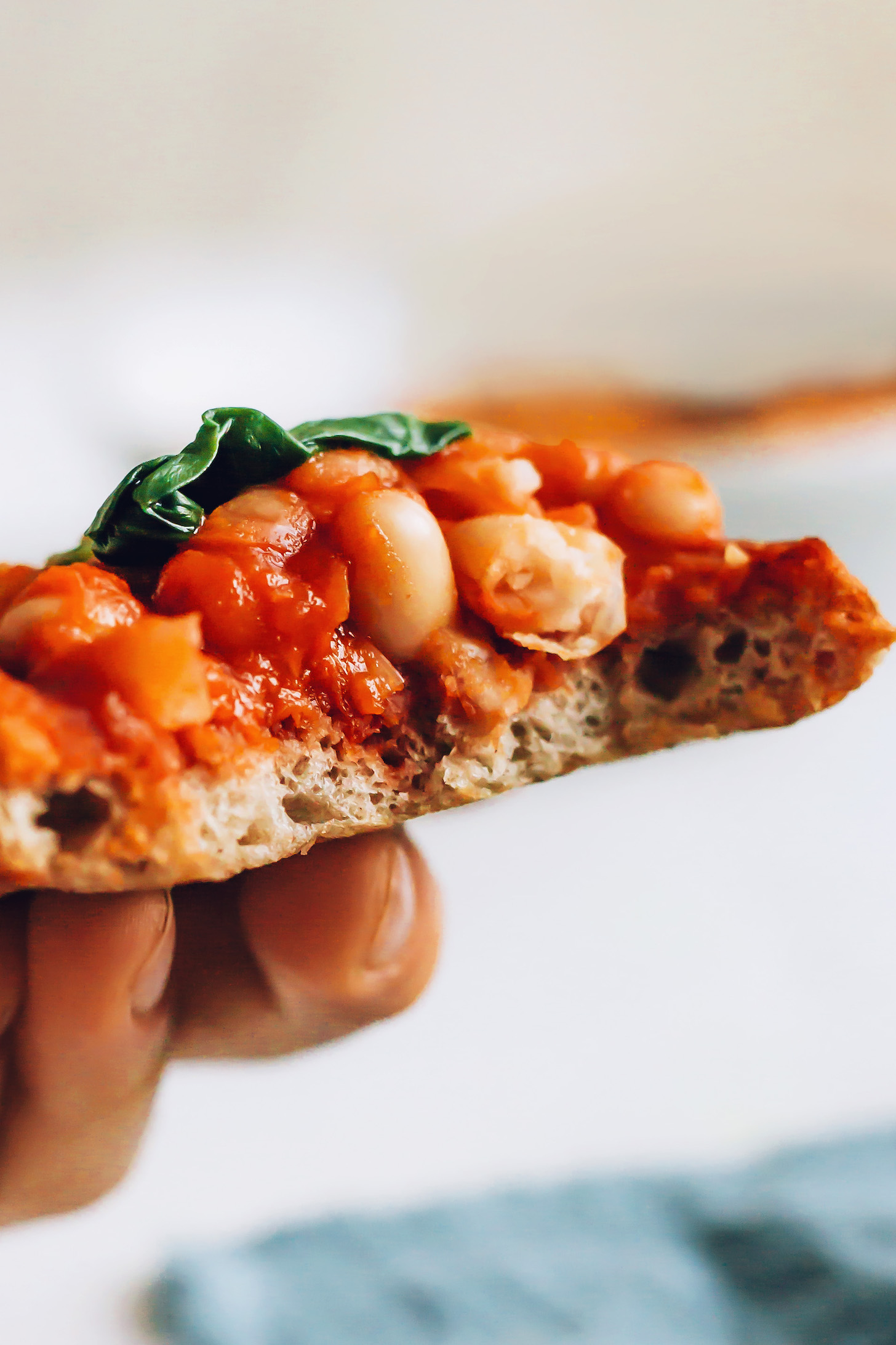 Holding up a slice of baked beans on toast