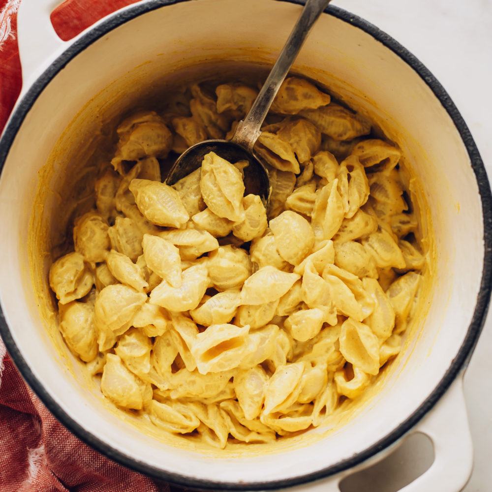 Vintage spoon in a pot of easy vegan mac and cheese