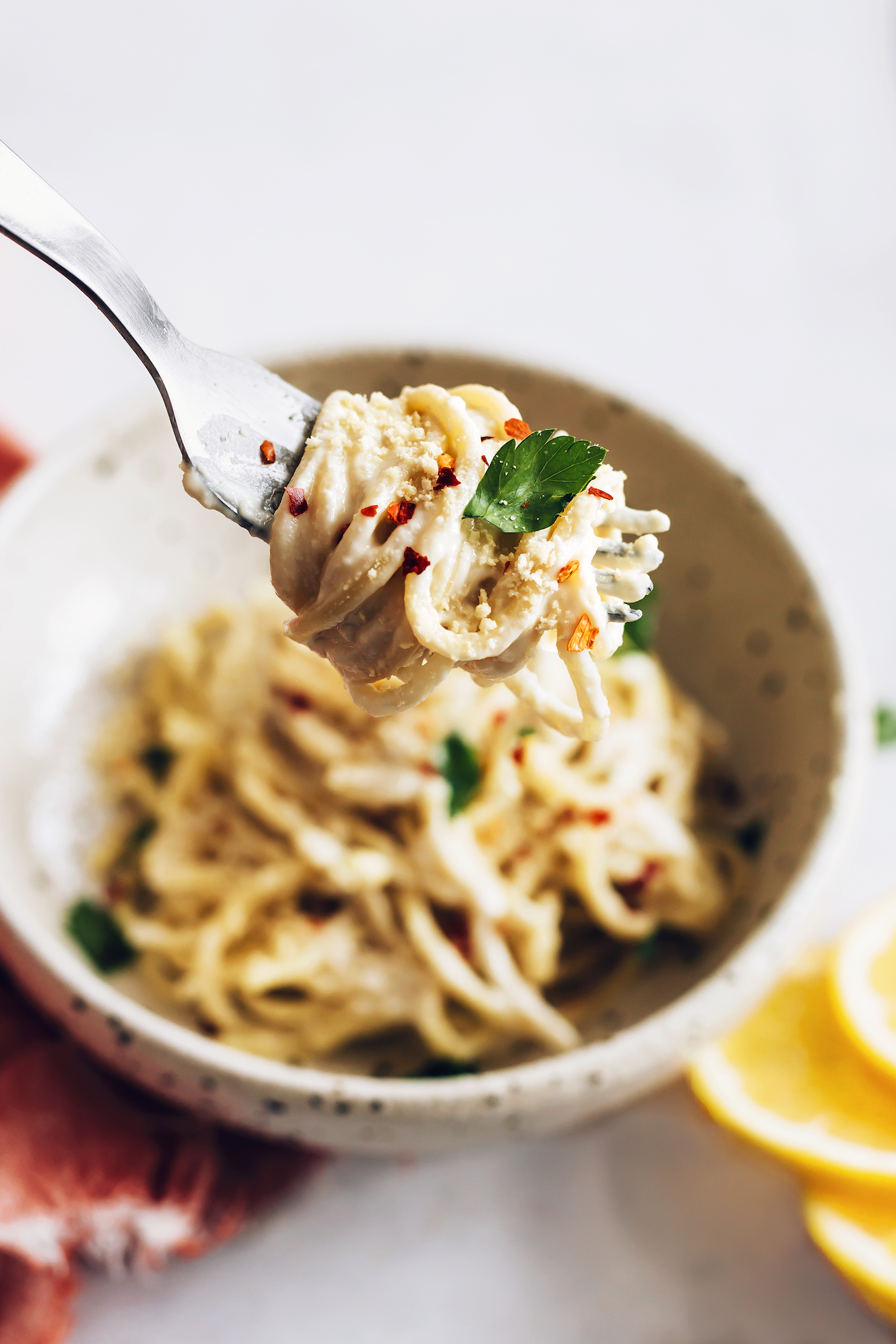 Close up shot of a bite of pasta al limone on a fork