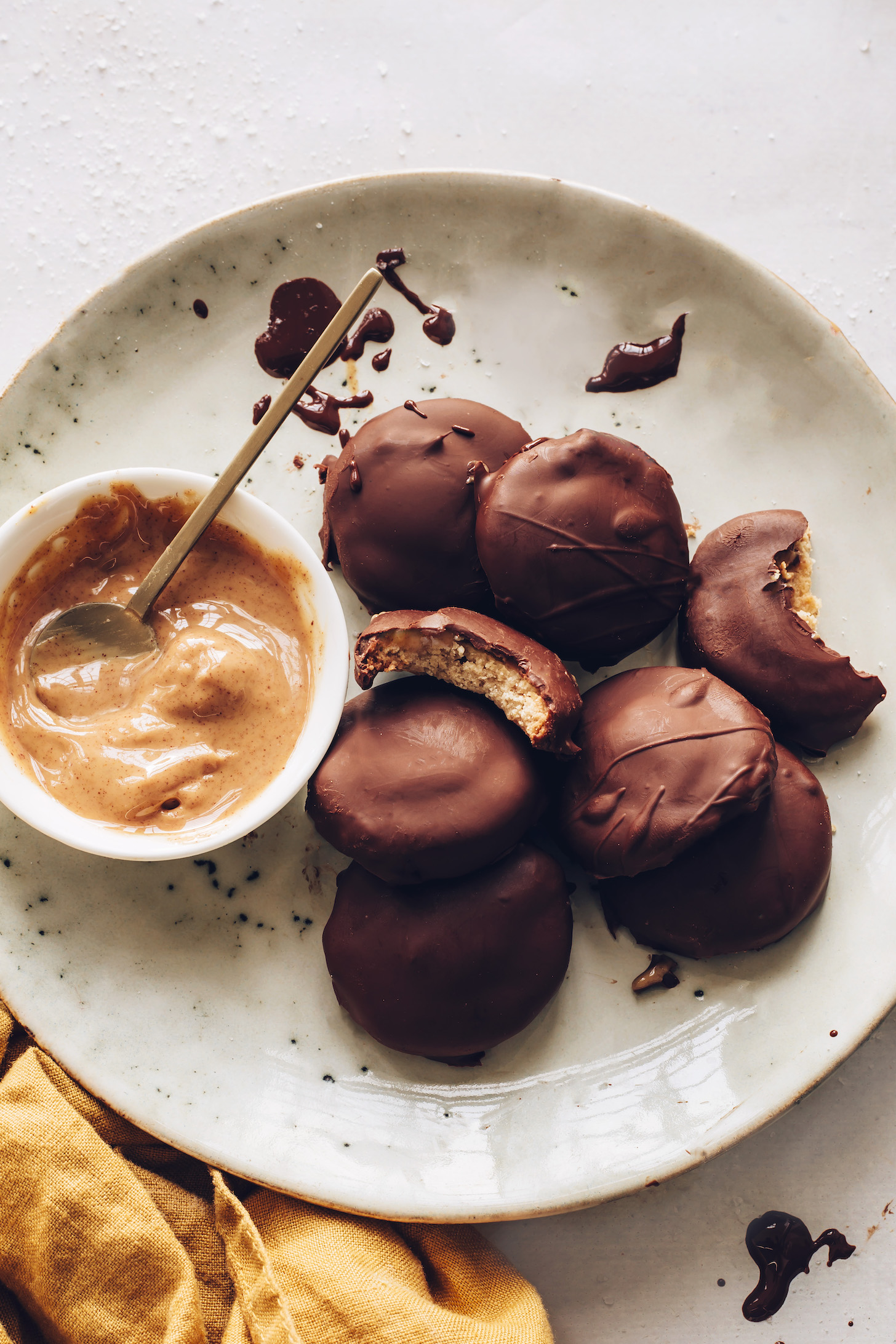 Bowl of peanut butter next to a plate of tagalong cookies