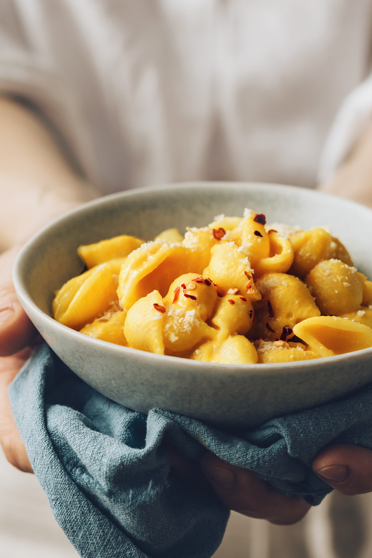 Holding a bowl of vegan mac and cheese