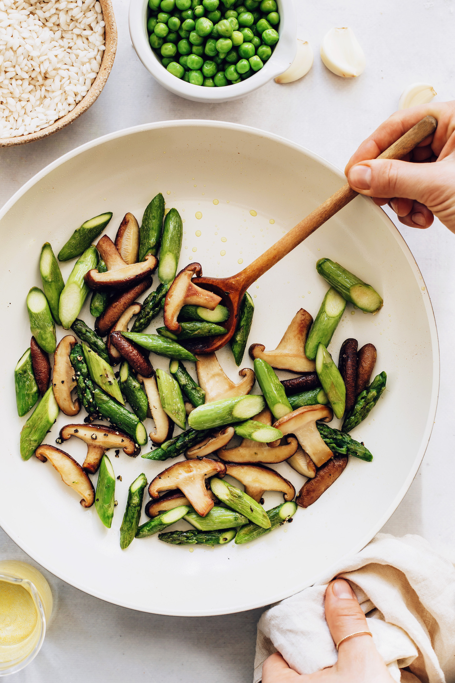Sautéing asparagus and mushrooms with salt and pepper