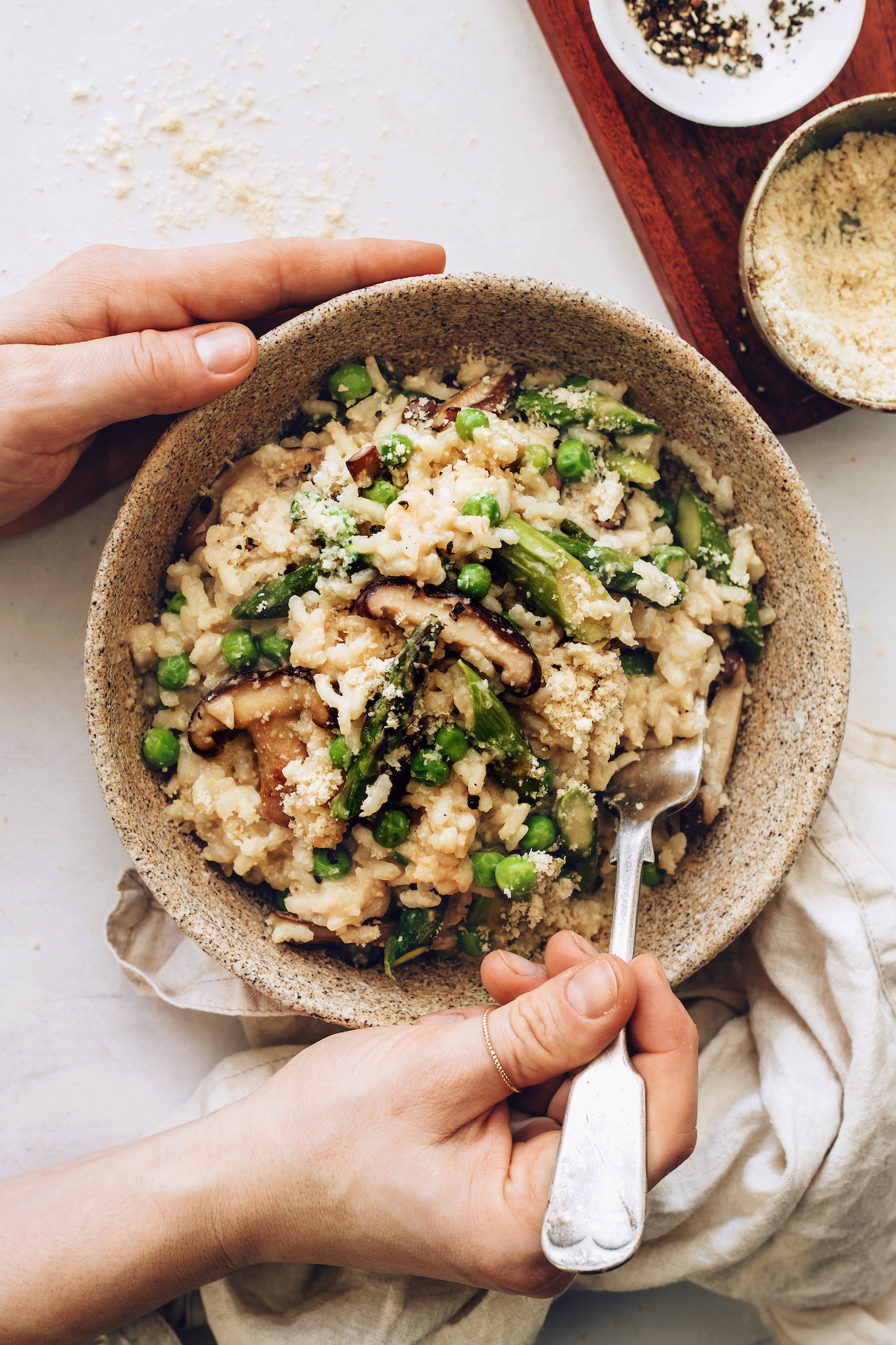Bowl of spring vegetable risotto seasoned with vegan parmesan and miso