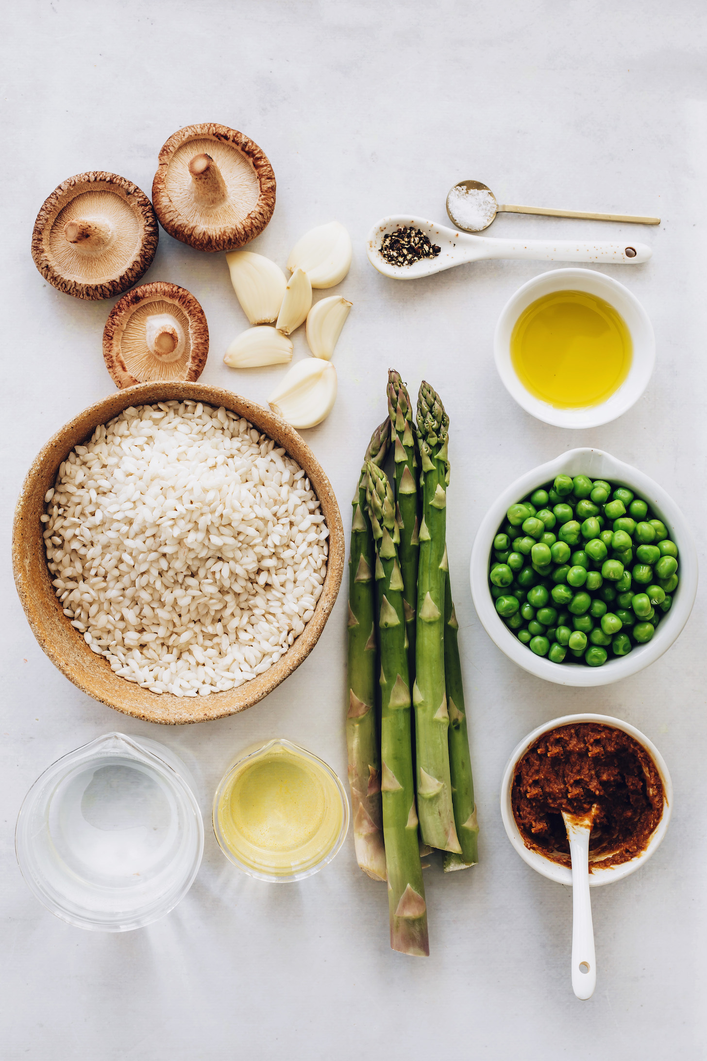 Shiitake mushrooms, garlic, arborio rice, water, olive oil, asparagus, white wine, miso paste, spring peas, salt, and pepper