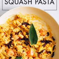 Pan of vegan butternut squash pasta topped with sage leaves