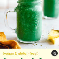 Two jars of our vibrant green lemonade smoothie with pineapple slices