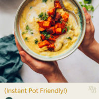 Holding a bowl of creamy split pea soup