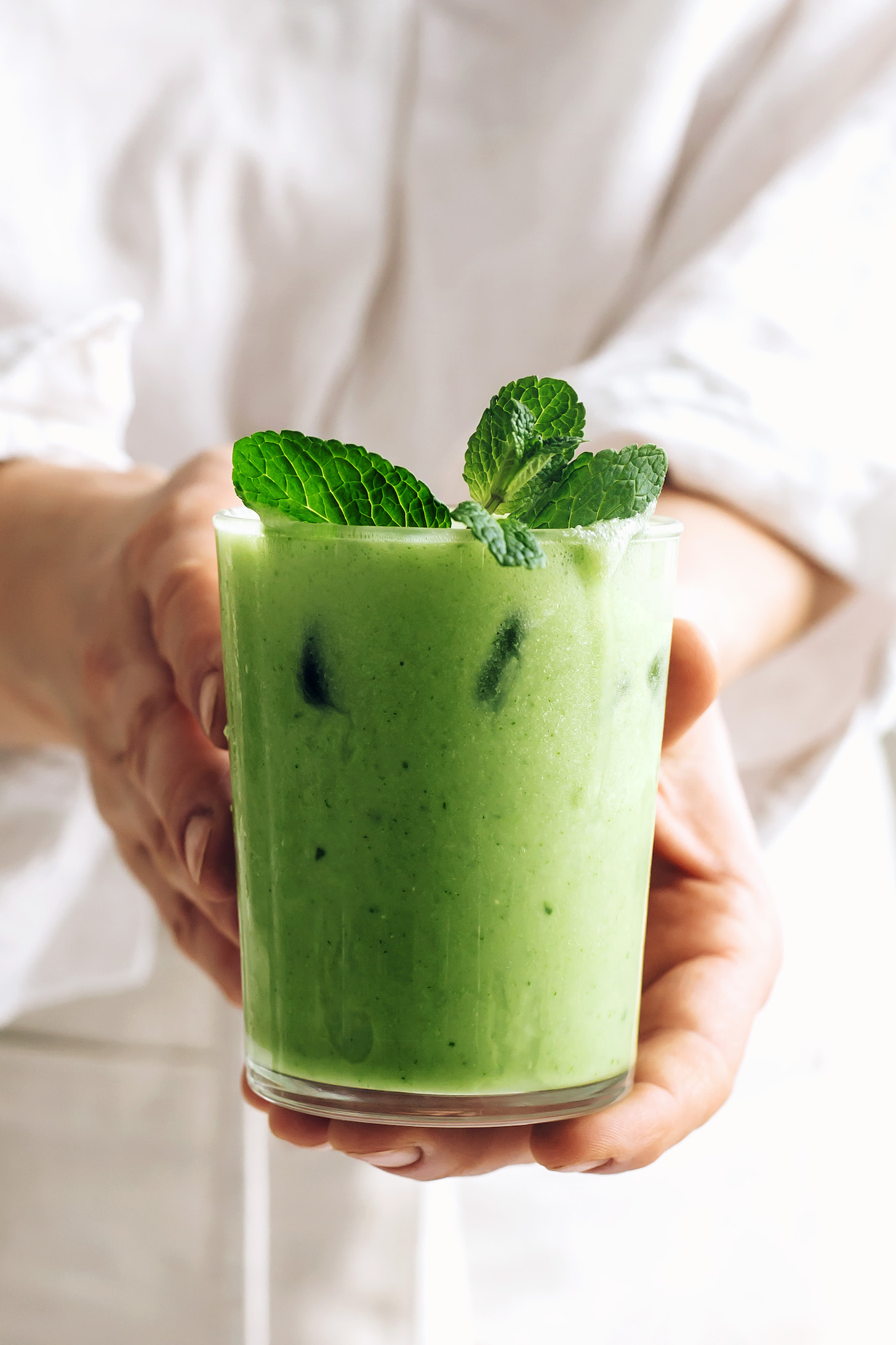 Holding an iced mint matcha latte