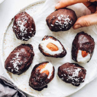 Holding a almond joy stuffed date on a plate