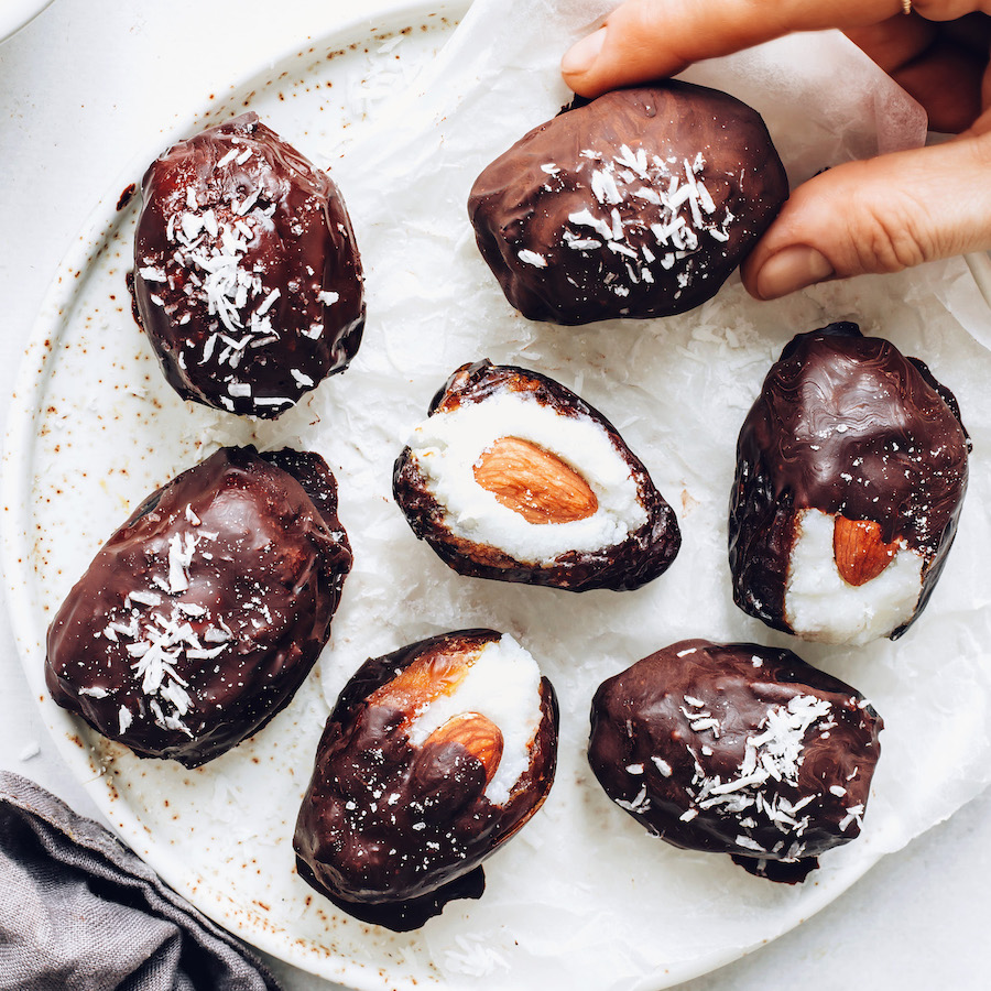 Holding a almond joy stuffed date on a plate