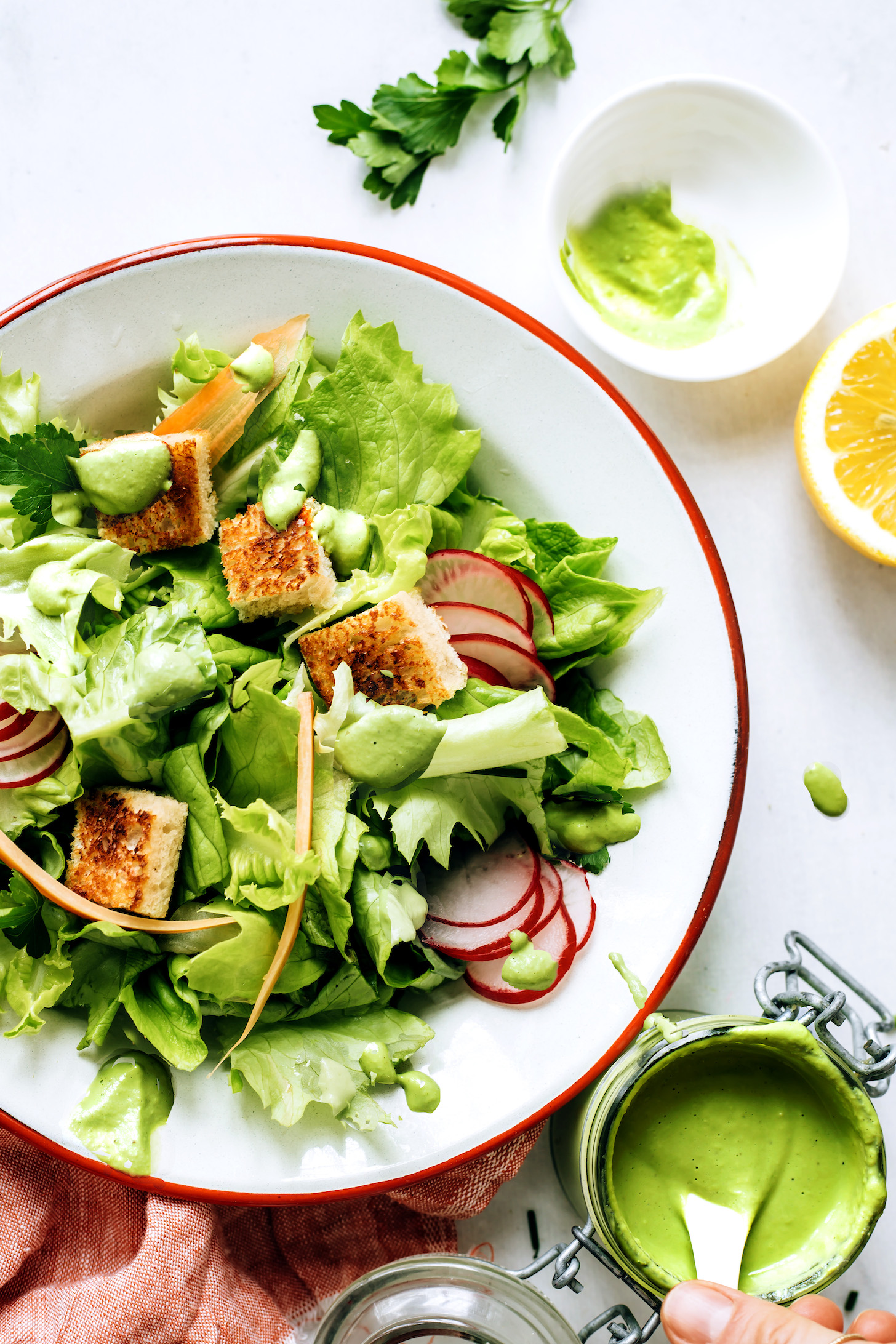 Salad drizzled with green goddess dressing