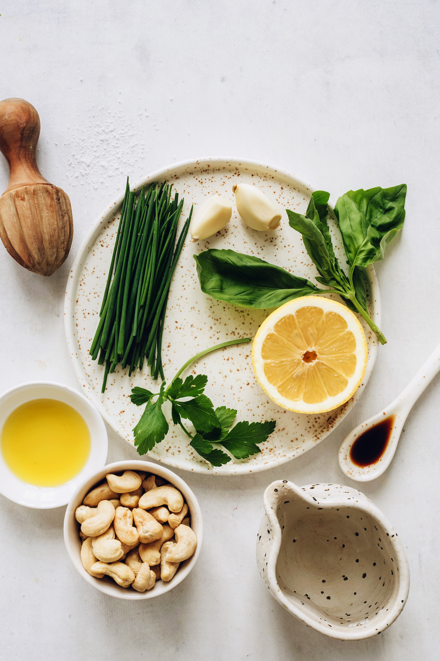 Fresh parsley, chives, basil, garlic, lemon, coconut aminos, cashews, olive oil, and water